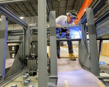 Vayakone Kanyavong, certified operator for Rockwell Collins, works on simulation and training equipment built in the Sterling facility.