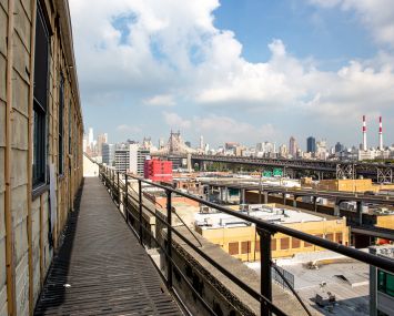 Normandy Real Estate Partners is converting a warehouse at 43-10 23rd Street into creative office space. The future roof deck has views of the Queensboro Bridge, looking out over Long Island City's industrial zone.