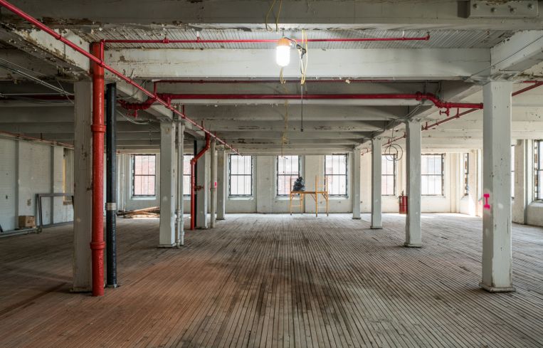 One of the older, heavy timber buildings at RXR's 47 Hall St project is in the midst of getting new utilities, windows and infrastructure.