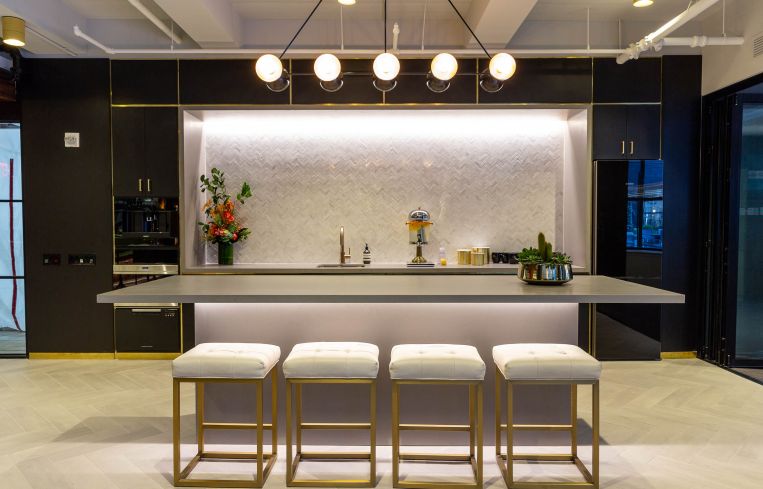 Brushed brass hardware and herringbone tiles are in keeping with the art deco design of the 1930s when 10 Grand Central was first constructed.