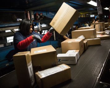 A woman works in a Fedex warehouse in Newark, N.J.