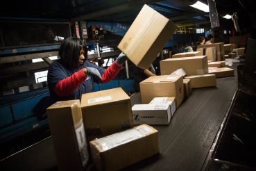 A woman works in a Fedex warehouse in Newark, N.J.