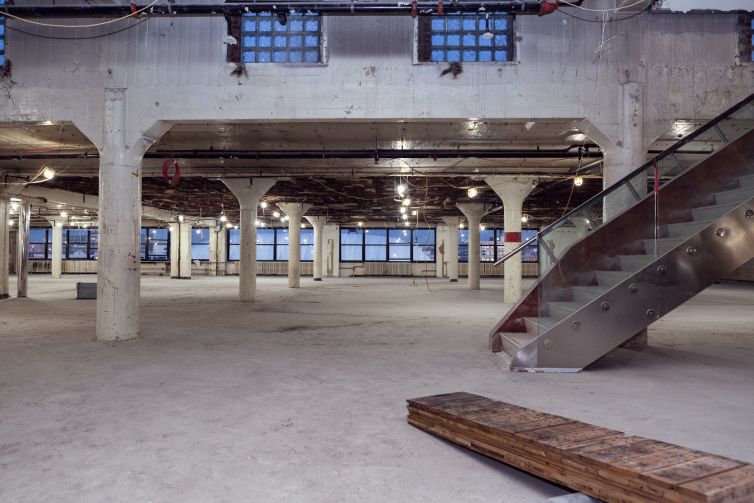 The huge, partially vacant top floor also has a 3,000-square-foot penthouse, accessed via the stairs on the right. 