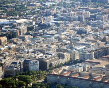 An aerial view of a city with squat office buildings.