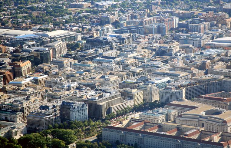 An aerial view of a city with squat office buildings.