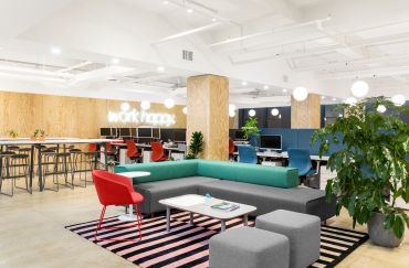 Poppin redesigned its office to create a homey feel with blonde wood, colorful furniture and a neon version of its "Work Happy" slogan.