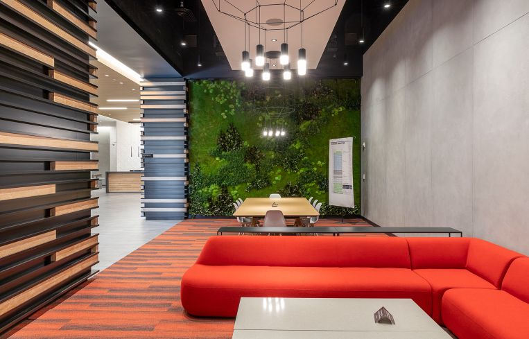The new lobby also features a sitting area with a preserved living plant wall.
