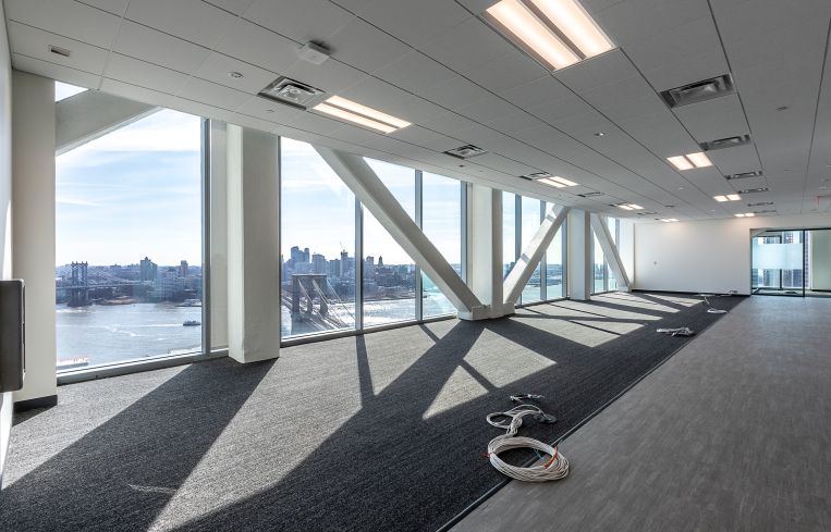 New offices for city agencies like the Department of Sanitation and the Human Resources Administration feature floor-to-ceiling windows.