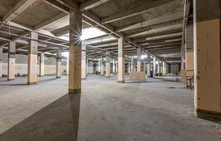 The NYPD will occupy unrenovated floors that still feature the building's old strip windows.
