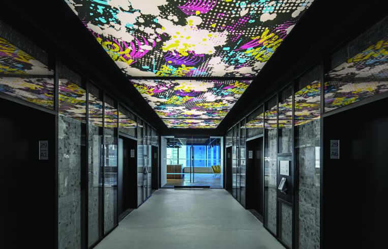The elevator lobby has graffiti graphics on the ceiling.