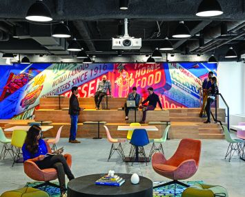 Booking.com designed its new offices with each part of the office following a different New York City theme. The cafeteria features a huge photo of the Nathan's Famous hot dog sign in Coney Island.
