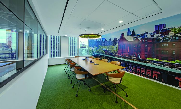 Another conference room features a greenery filled light fixture and a skyline view.