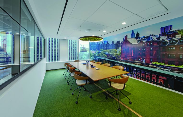 Another conference room features a greenery filled light fixture and a skyline view.