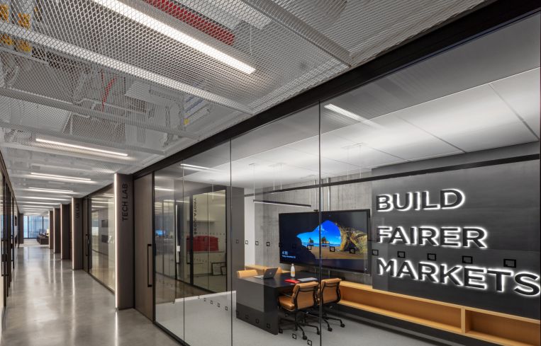 One conference room is emblazoned with the message "Build Fairer Markets," the company's motto. It has a high-tech display so the company's programmers can do code reviews there.