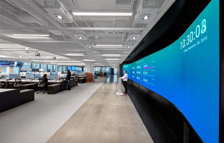 The main work space features a 30-foot-long screen and a pedestal where IEX opens and closes its stock exchange every day.