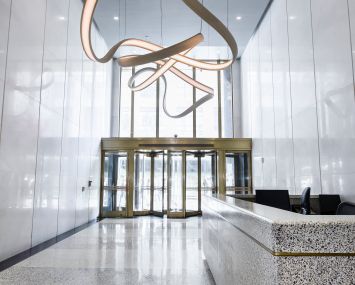 Kaufman Organization renovated the lobby of 450 Seventh Avenue and added a twisty bronze chandelier.