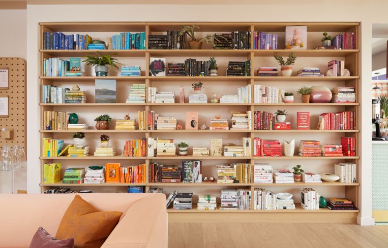 The second lending library is color-coded and has titles by and about women.