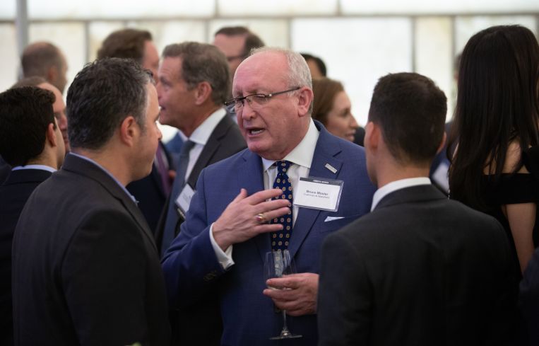 Cushman & Wakefield chairman of global brokerage, Bruce Mosler, mingling with a couple other gala attendees.