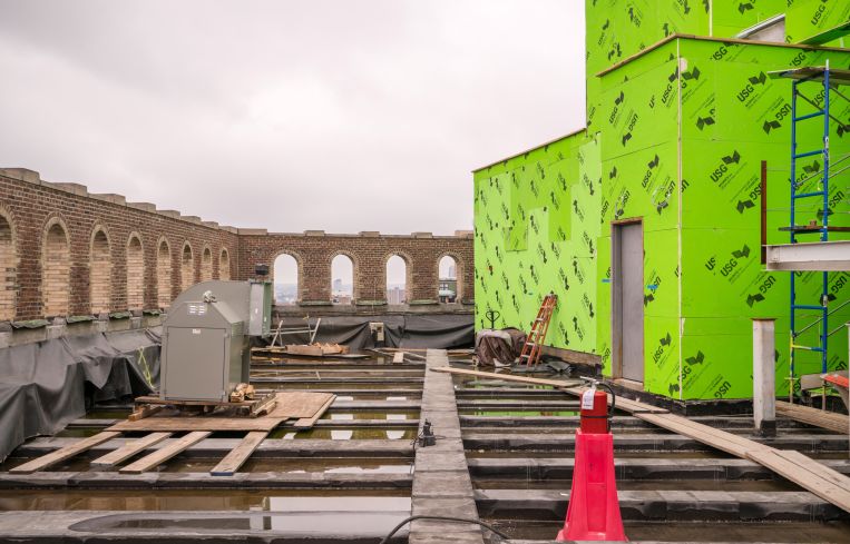 The building's original rooftop features arched openings and will become a shared landscaped terrace for tenants.