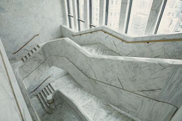 The executive floors at 550 Madison have a massive white marble staircase that links all three floors.