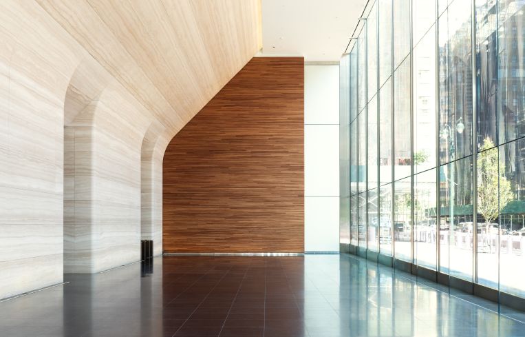 Warm accent woods on the side walls help accent the cool white walls and the dark Canadian stone floors.