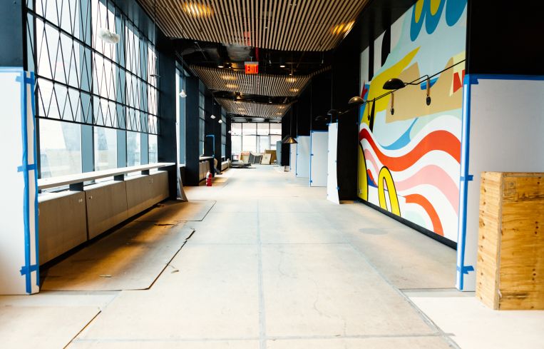 The walls of the lobby have been painted with murals from local artists celebrating the Navy Yard's history.
