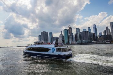 An NYC Ferry plies the East River.