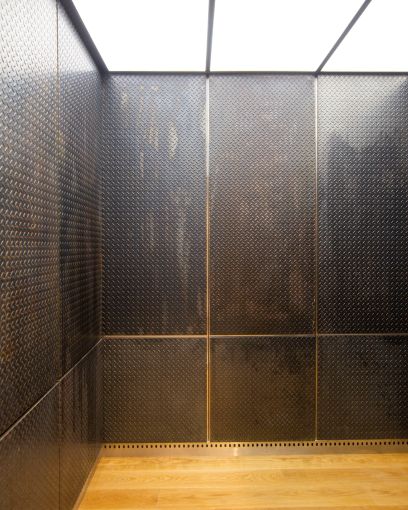 The new elevators feature aged metal siding, wooden floors and lit up ceilings.