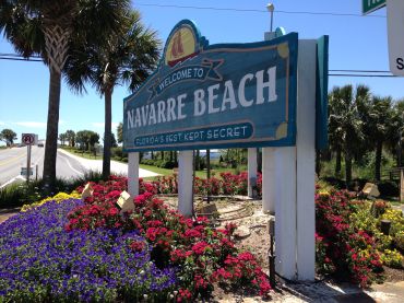 A sign welcoming visitors to Navarre Beach. 