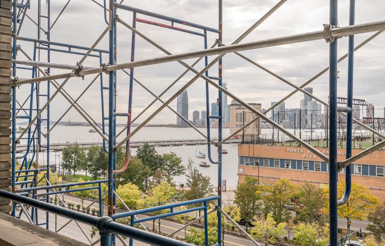 Views through the scaffolding of Pier 40, the Hudson River and New Jersey.