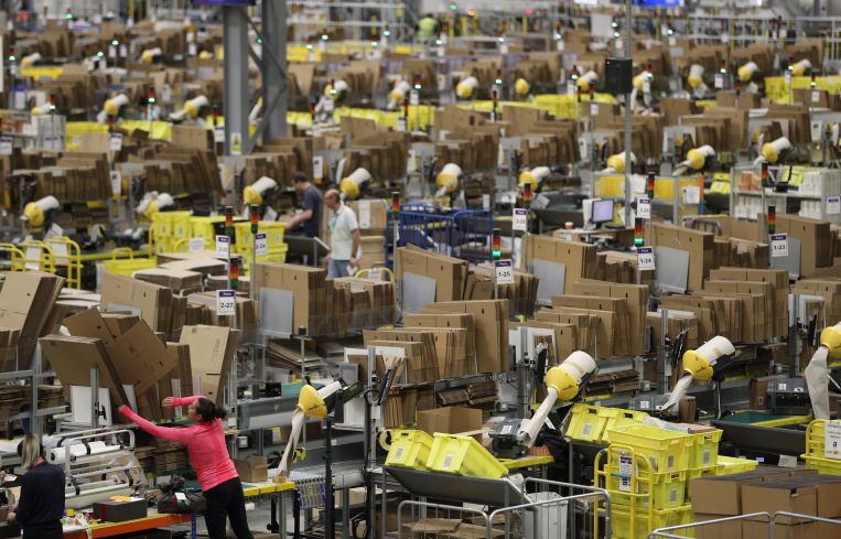 Humans and machines at work at an Amazon Fulfillment center.