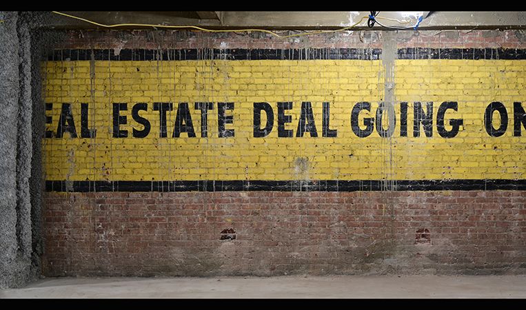 A full view of the vintage real estate ad, which was originally painted on the exterior of the building next door.