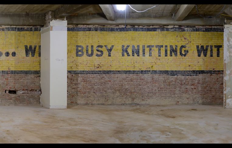 The sign uncovered on the fifth floor reads, "QUIET! We're busy knitting with Nomotta Yarns."