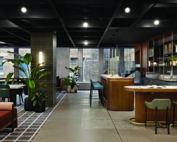Fogarty Finger Architecture designed a mid-century modern lounge at 1700 Broadway that includes a classic wooden bar.