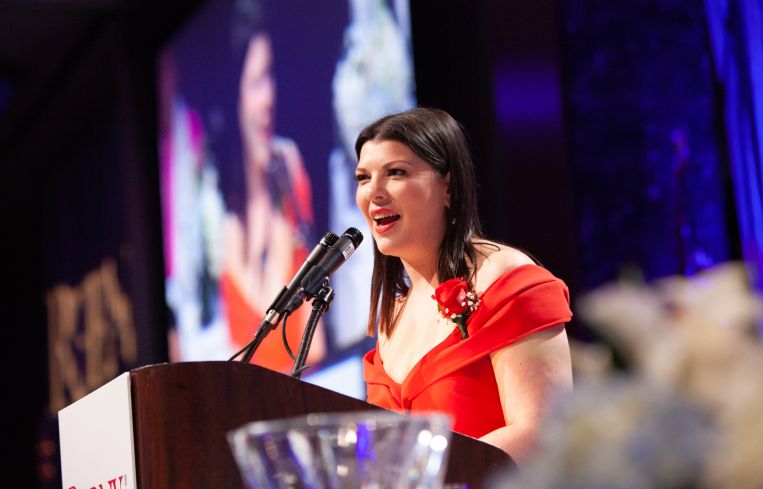 Honoree Robin Fisher accepts the Young Real Estate Professional of the Year Award.