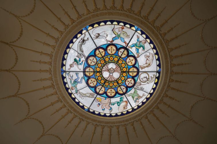 Glass medallions that covered the light fixtures depict characters and animals from the cirucs.