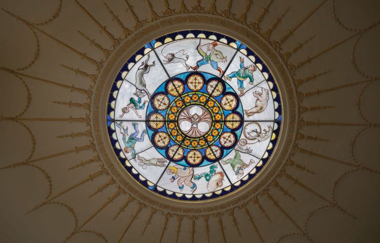 Glass medallions that covered the light fixtures depict characters and animals from the cirucs.