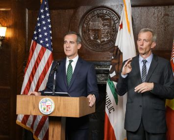 Mayor Eric Garcetti, left, addresses the coronavirus outbreak in a video announcement.