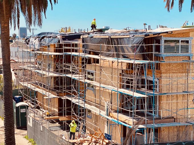 Crews continue work at a multifamily development on Willoughby Avenue off La Brea Avenue.