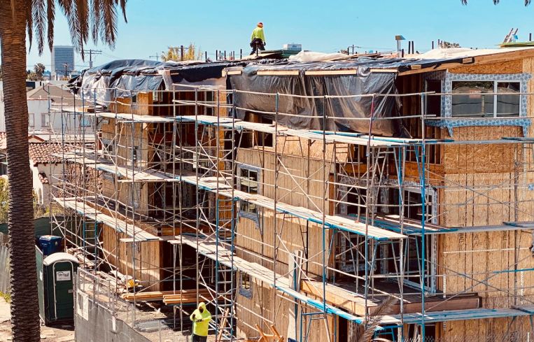Crews continue work at a multifamily development on Willoughby Avenue off La Brea Avenue.
