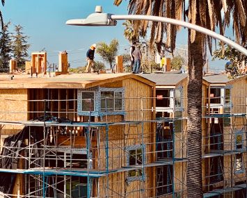 Crews continue work at a multifamily development on Willoughby Avenue off La Brea Avenue.