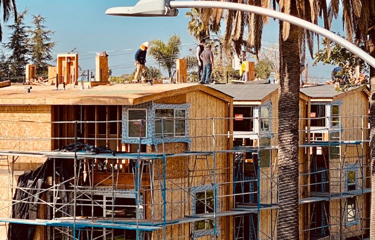 Crews continue work at a multifamily development on Willoughby Avenue off La Brea Avenue.