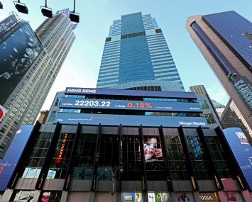 A very tall, glass building from the street level.