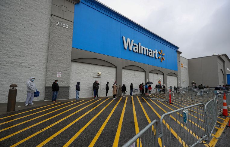 An empty WalmAmericans line up for supermarkets due to Covid19 pandemicart parking
