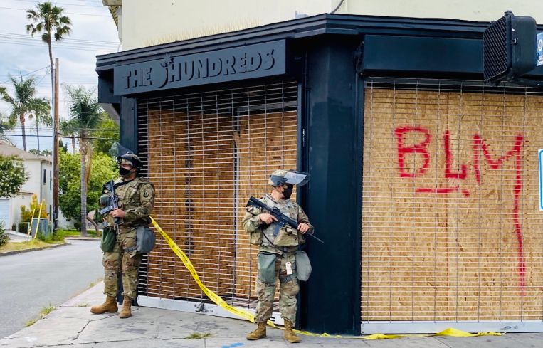 The Hundreds, a streetwear outlet at 501 Fairfax Avenue, is watched by National Guardsmen.