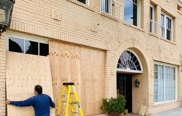 The store at 119 Larchmont is boarded up Tuesday.