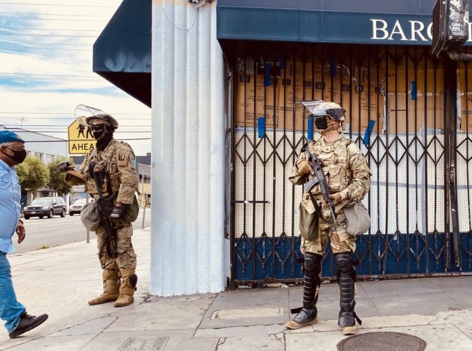 Bargain Fair at Beverly Boulevard and Fairfax Avenue is boarded up with National Guardsmen on June 2.