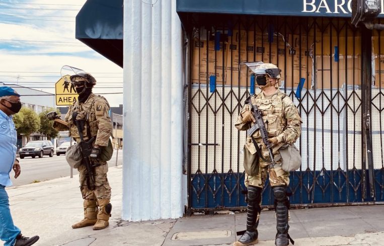 Bargain Fair at Beverly Boulevard and Fairfax Avenue is boarded up with National Guardsmen on June 2.