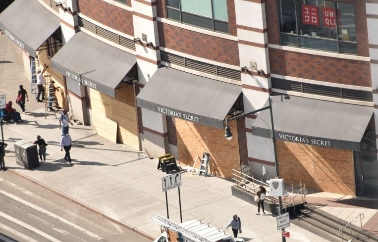 Workers board up a portion of the Atlantic Terminal mall near the intersection of Atlantic and Flatbush Avenues.