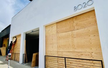 A vacant retail property is boarded up on Melrose Avenue in Los Angeles during the recent civil unrest.